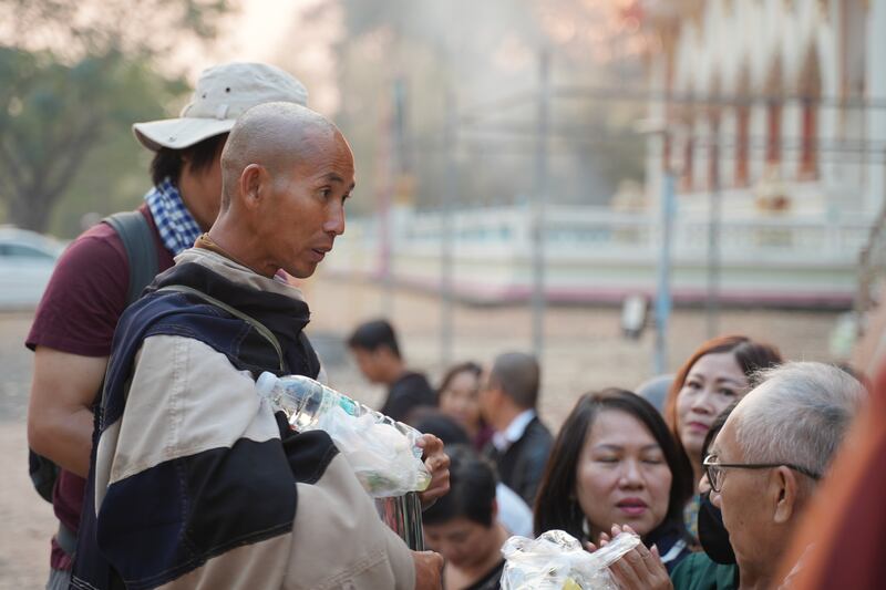 Vietnamese monk Thich Minh Tue walks during alms rounds in Nong Bua, Nakhon Sawan province, Thailand, Feb. 13, 2025.