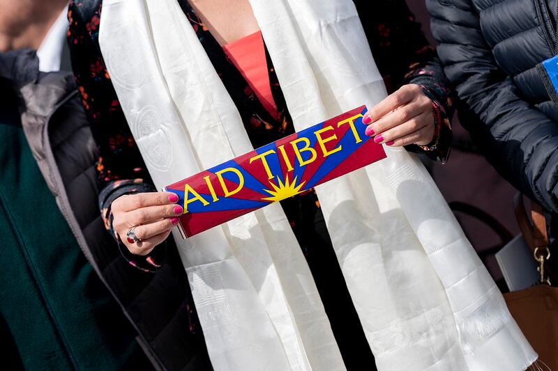 A person holds an “Aid Tibet” sticker before a press conference to highlight the plight of Tibetans, on Capitol Hill in Washington, D.C., on March 28, 2023.