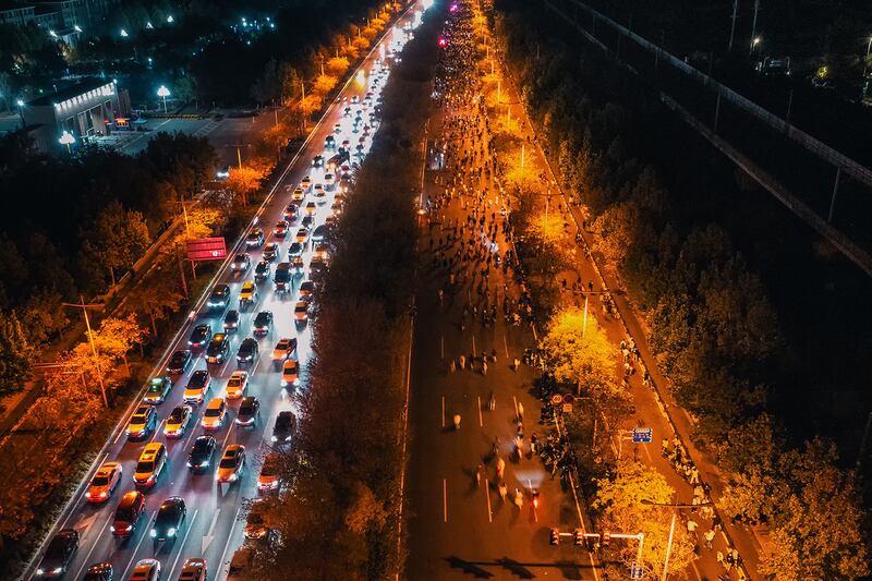 Thousands of college students ride bicycles on the Zhengkai Road in Zhengzhou, in China's Henan province, Nov.  9, 2024.