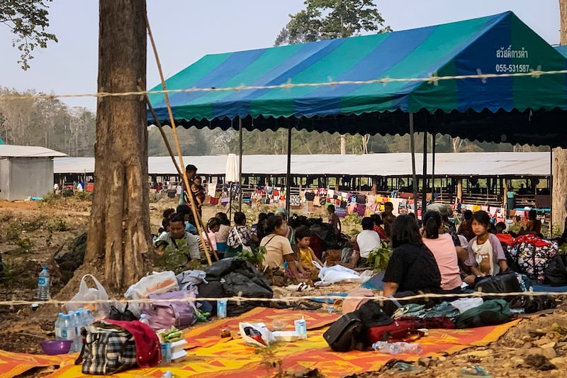 People fleeing fighting between the Myanmar military and opposition forces shelter on the Thai side of the Moei river, in Mae Sot district on April 7, 2023.