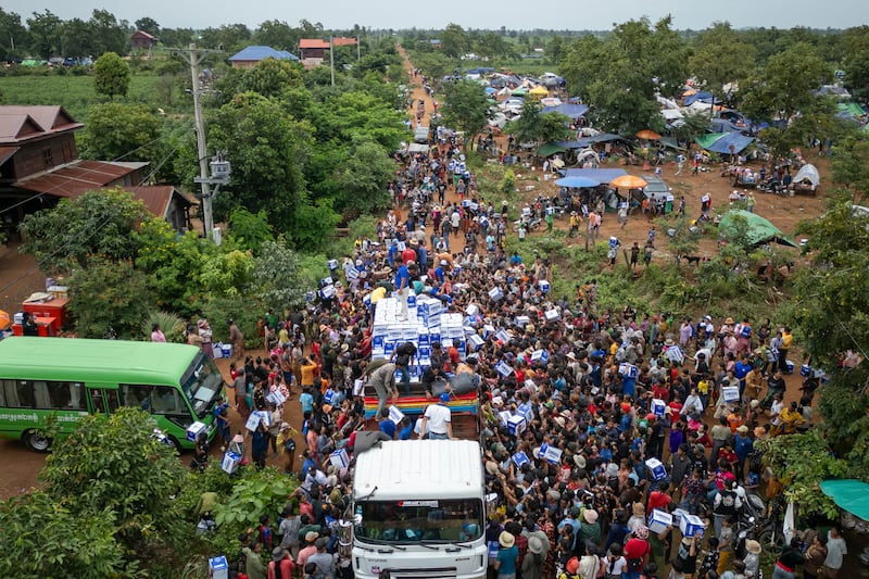 Displaced Cambodians receive water at the Battkhao Resettlement Camp in Oddar Meanchey province, Cambodia, July 26, 2025.